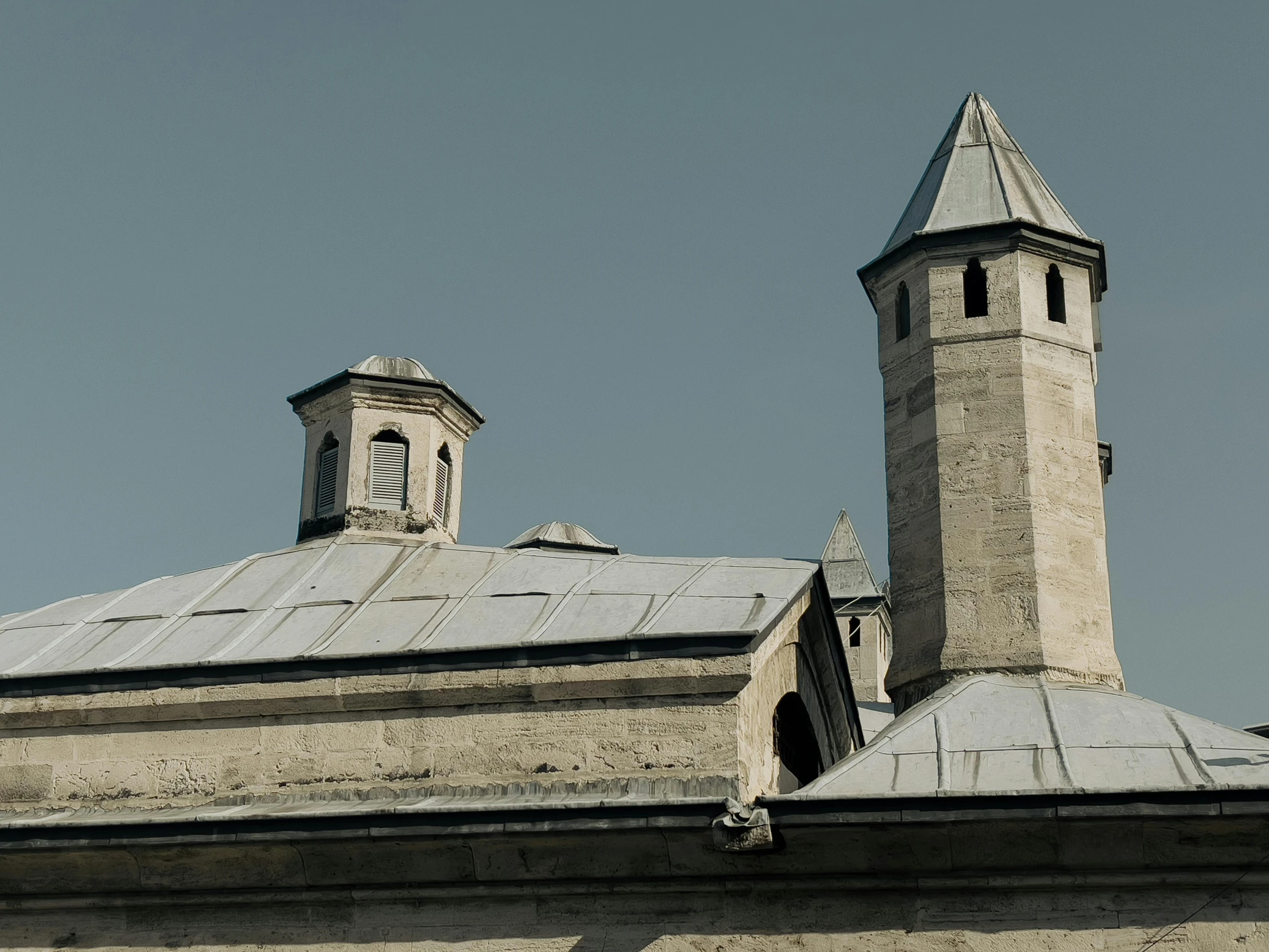 there is an old building with two steeples and a clock