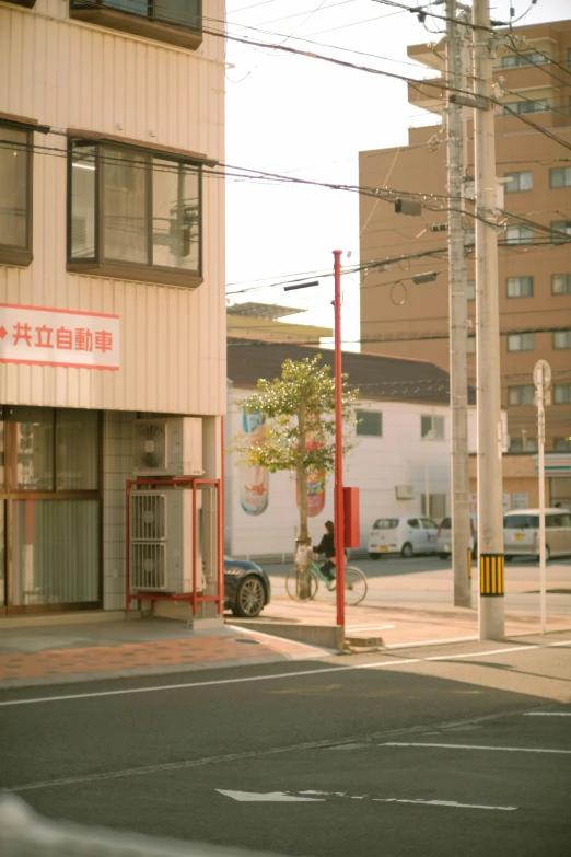 a small building with cars parked on the street