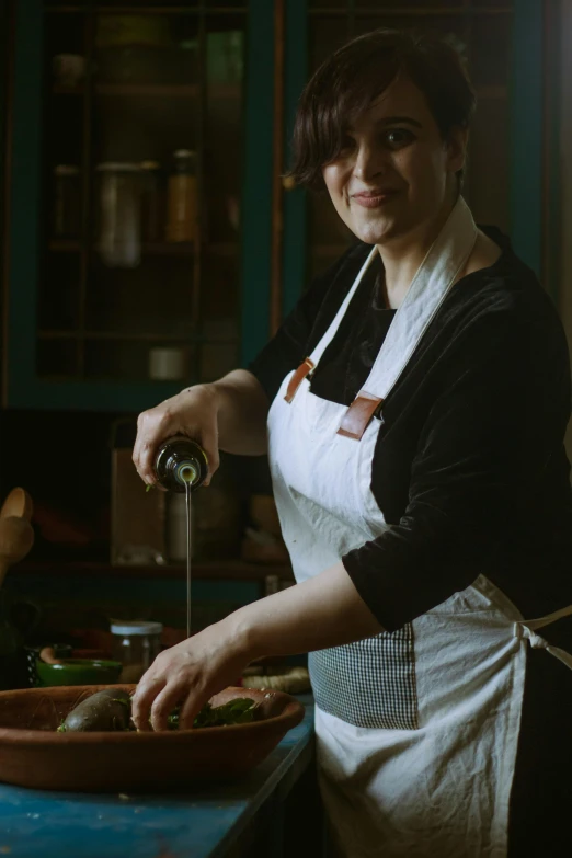 a young woman is cooking soing on the stove