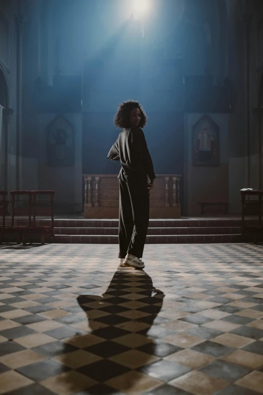 a person stands on a checkered tiled floor