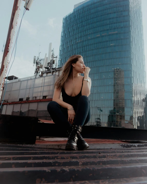 a beautiful woman sitting on top of steps in a city