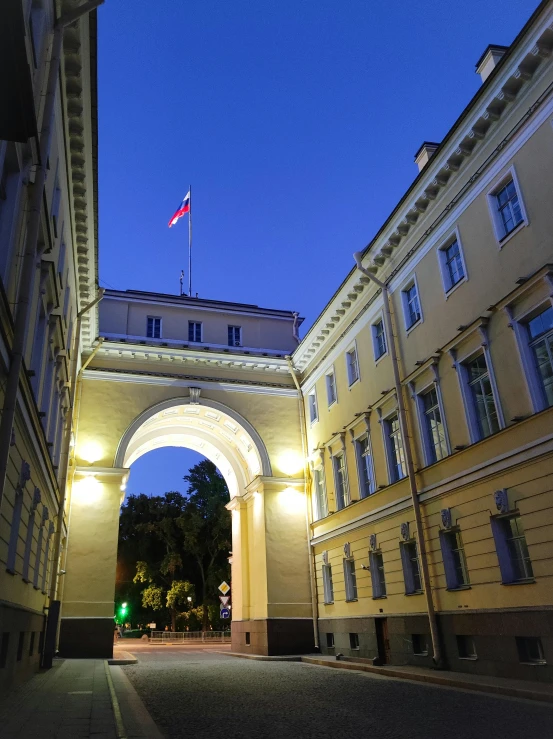 the entrance to an archway that has lights at the top