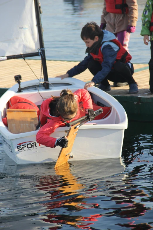 a young child is rowing a small boat