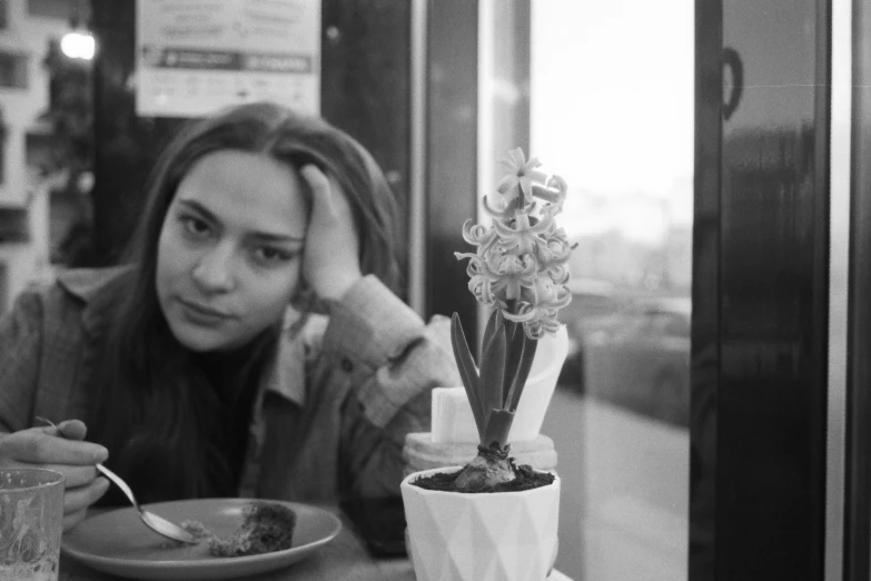 a woman eating food at a table outdoors