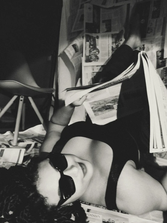 woman laying on the floor with her back to the magazine