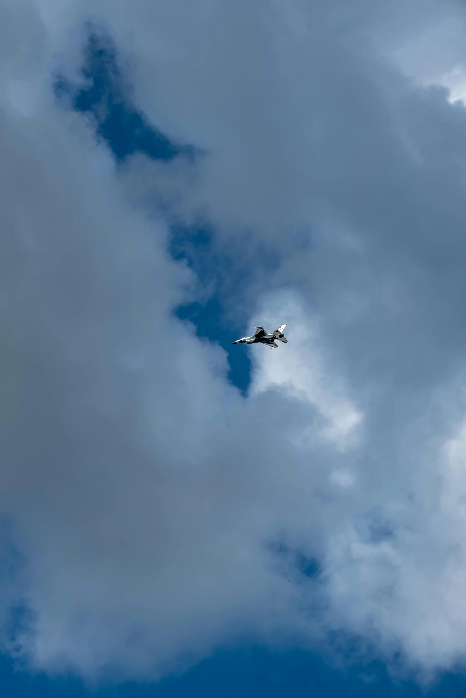 an airplane flying in the cloudy sky