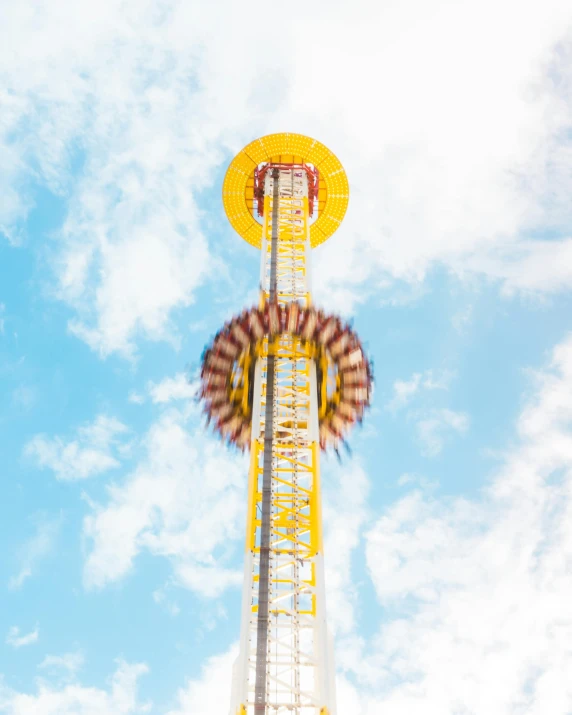 a ferris wheel is sitting under a bright blue sky