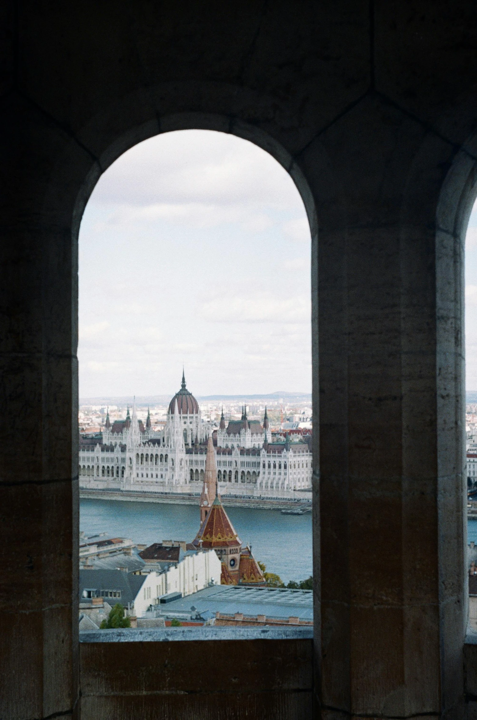 some tall buildings are sitting next to a big body of water