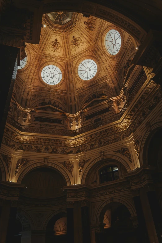 a large round ceiling with two windows and clocks in it