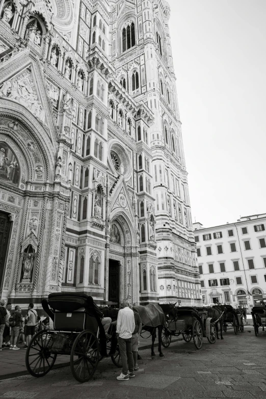 horse drawn carriage in front of a huge cathedral