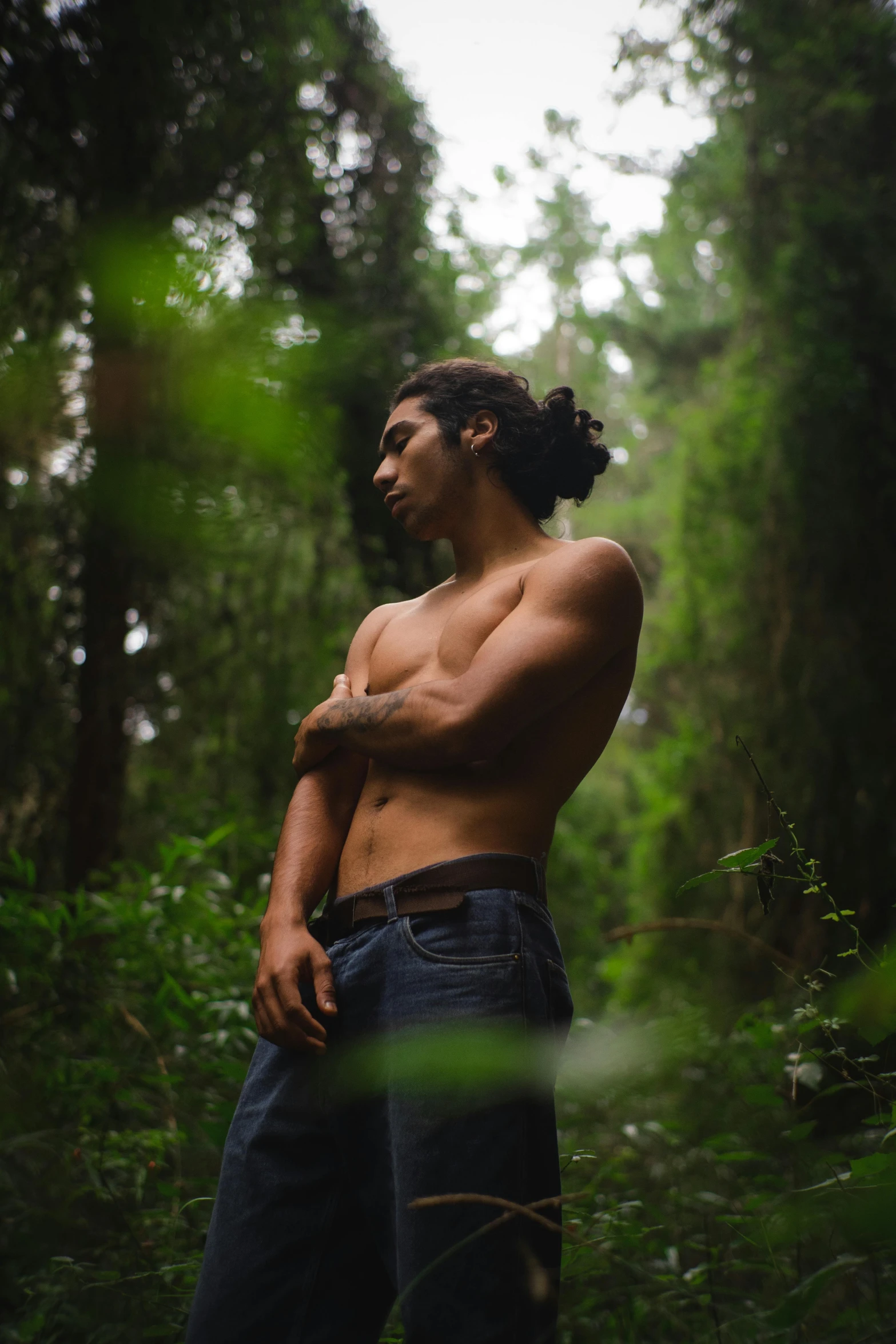 a man with  standing in the middle of a forest