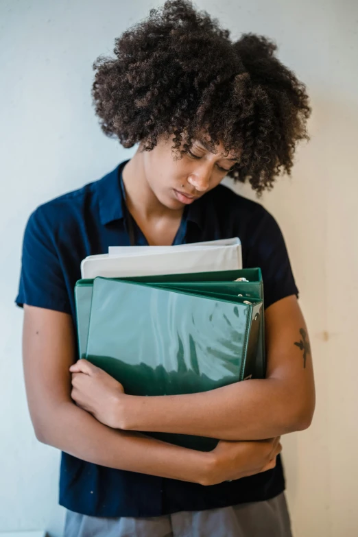 a person standing and holding a file case