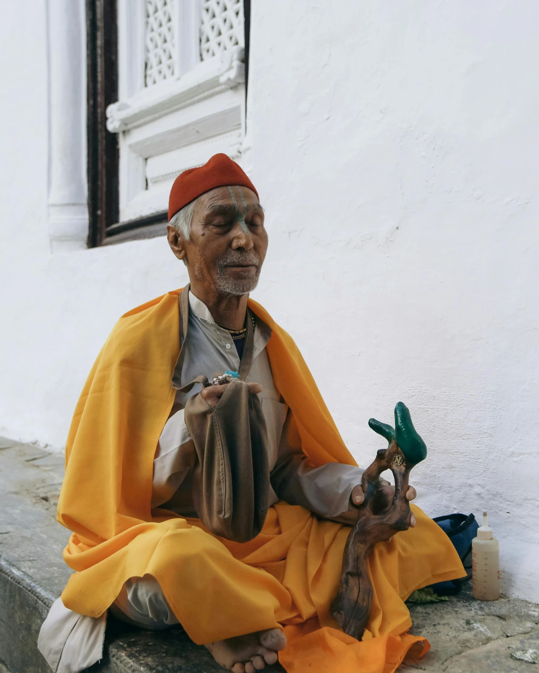 a man in a red cap is sitting on steps