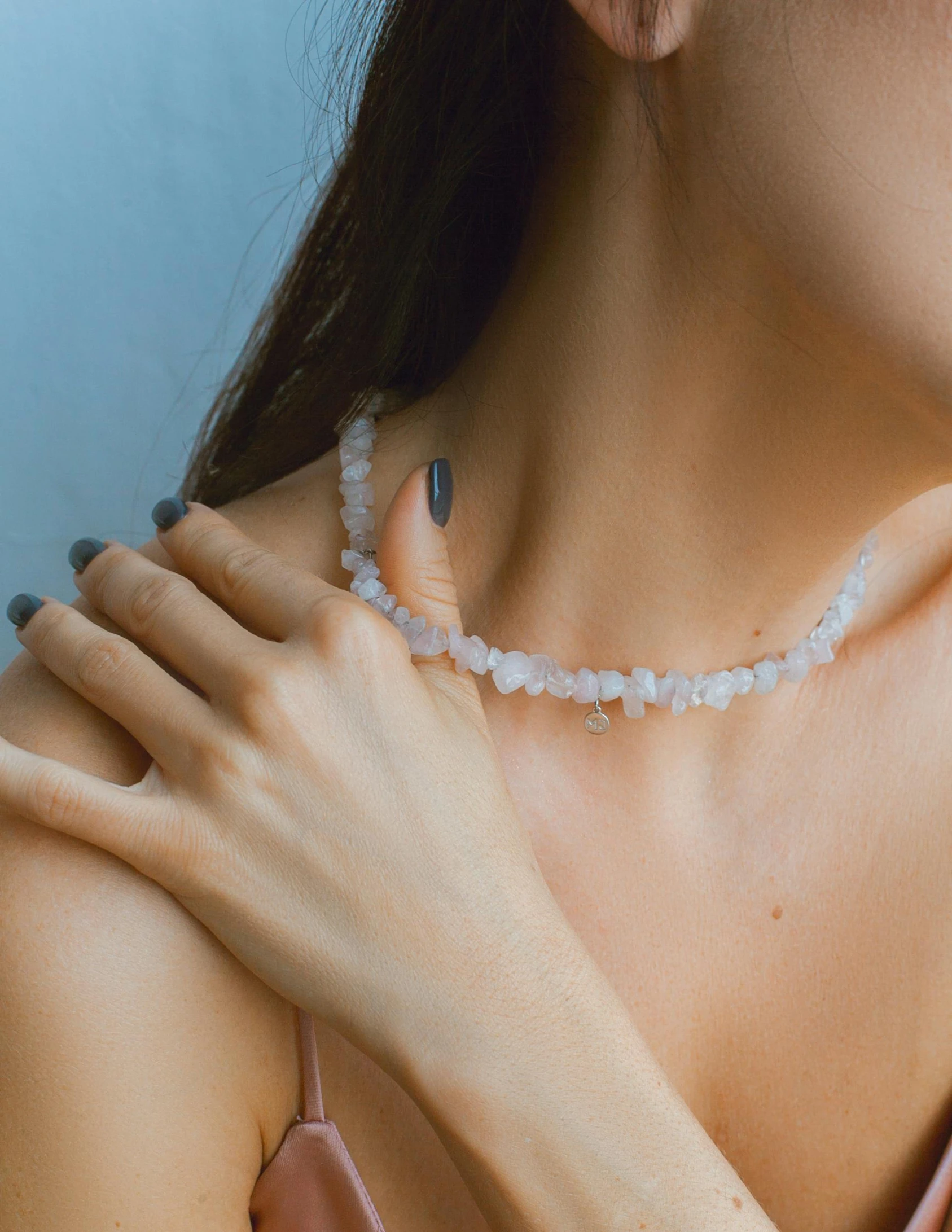 a woman wearing a white stone choker necklace