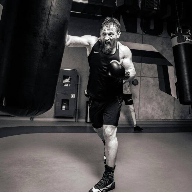 a man with a punching glove poses for a picture