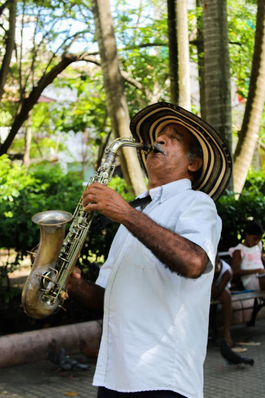 a man playing the saxophone in a park