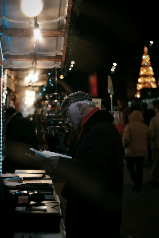 a man with head covered in a covering working on a laptop computer