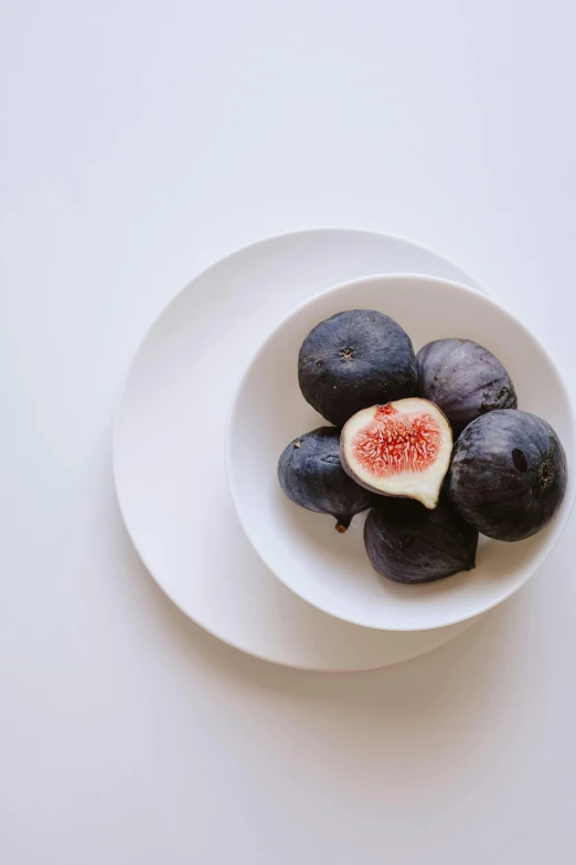 some figs are on a white plate