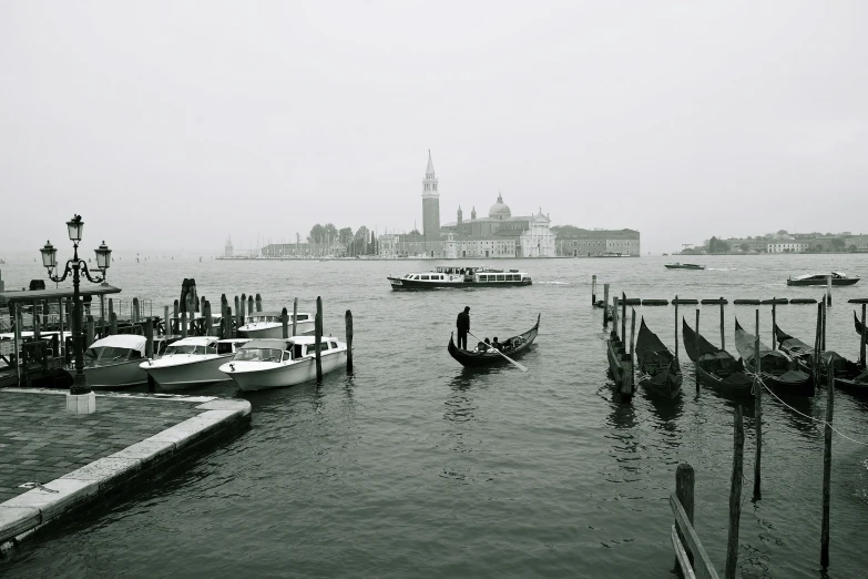 a body of water with boats docked near a city