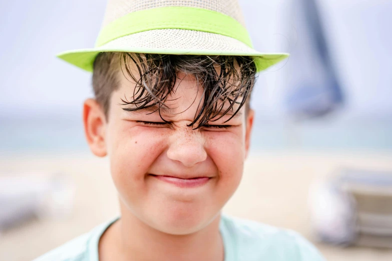 a  smiles while wearing a green hat