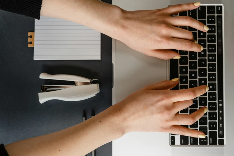 a pair of hands on a computer keyboard