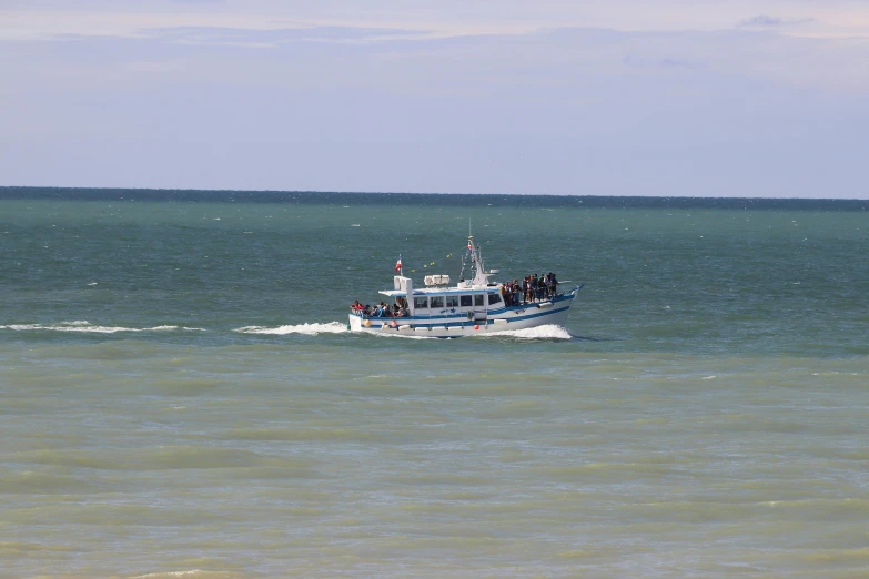 a boat traveling through an open ocean on a sunny day