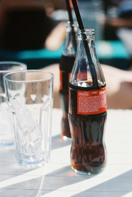 a bottle and some glasses are sitting on a table