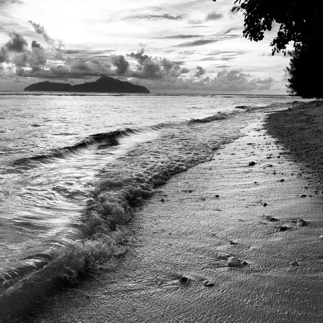 the waves are crashing onto the sand of the beach