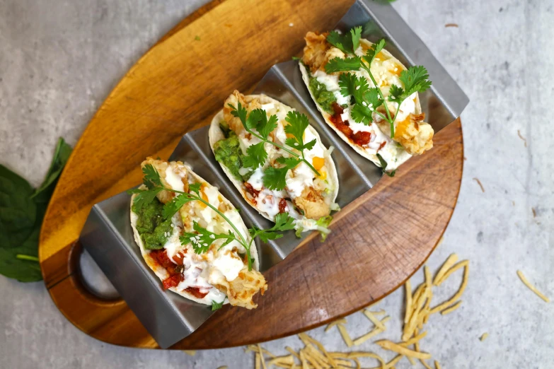 a table topped with an assortment of tacos