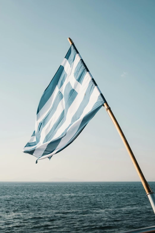 an italian flag flying in the wind on a boat