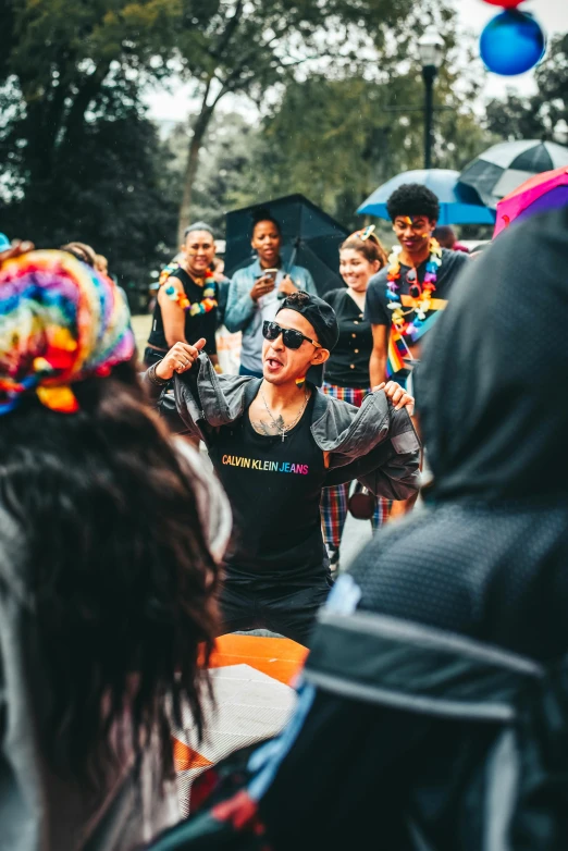 a group of people stand in the rain