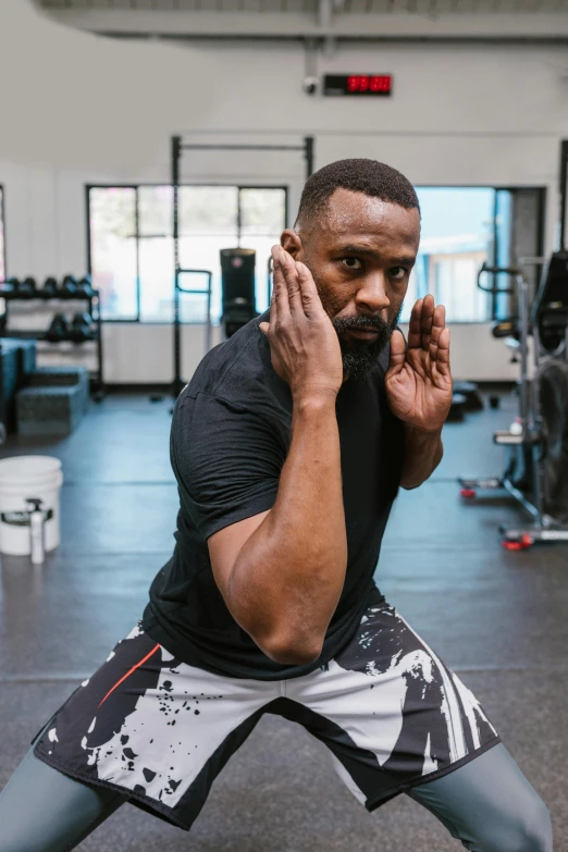 a man doing squats in a gym