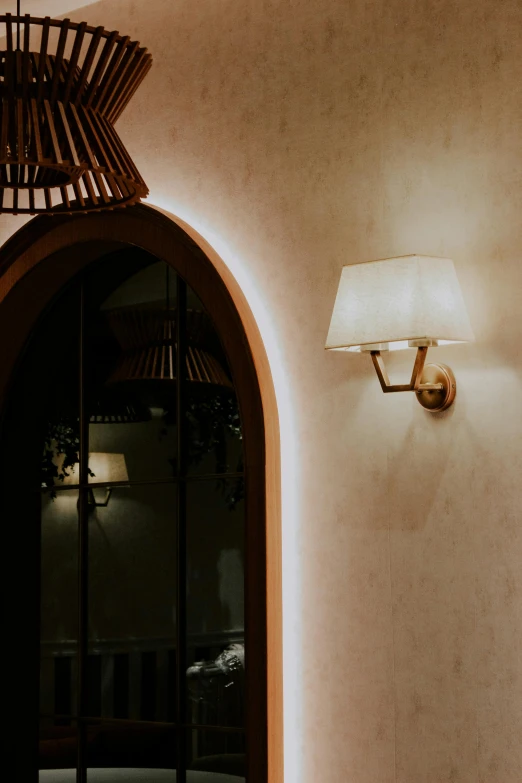 a modern wall sconce attached to a stone arch