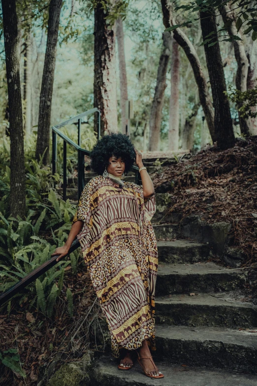 a woman is posing on some steps