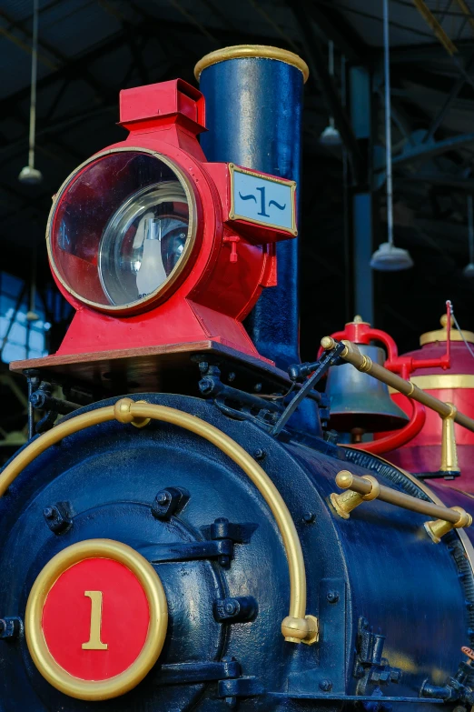 the front of a blue and red train car with its number on it