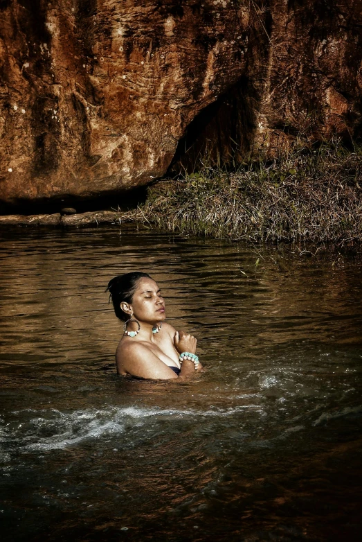 woman in water posing on her belly