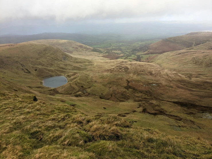 looking down into the mountains from a very big hill