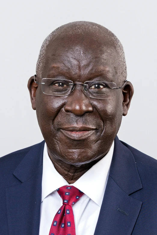 a close up of a person wearing a suit and tie