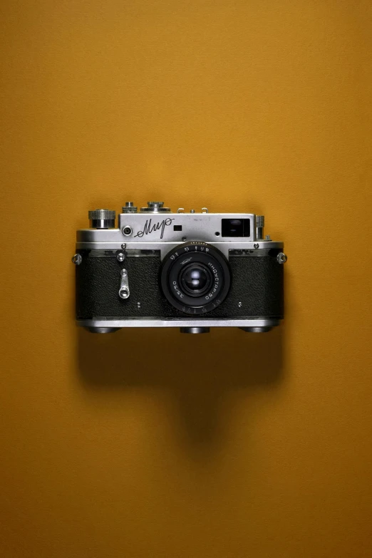 an old style camera is on the wall