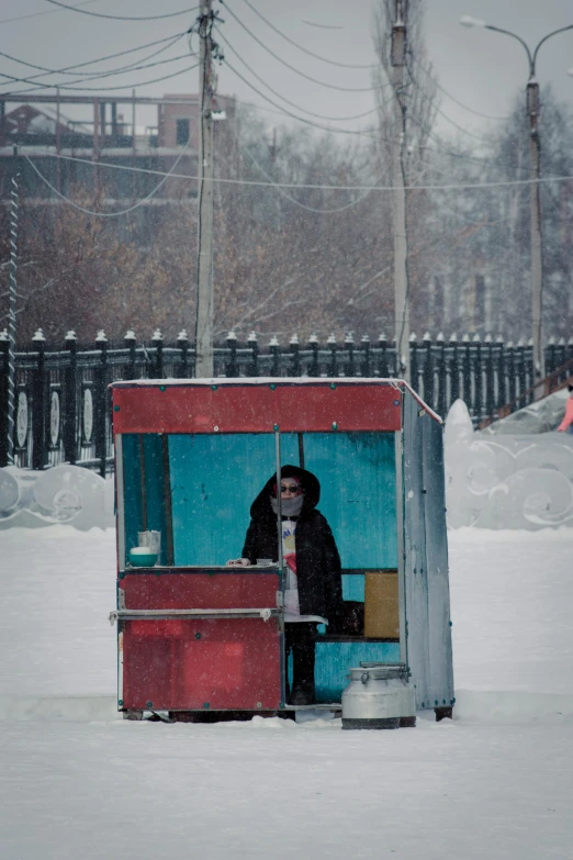 a man sitting in a covered container on the snow