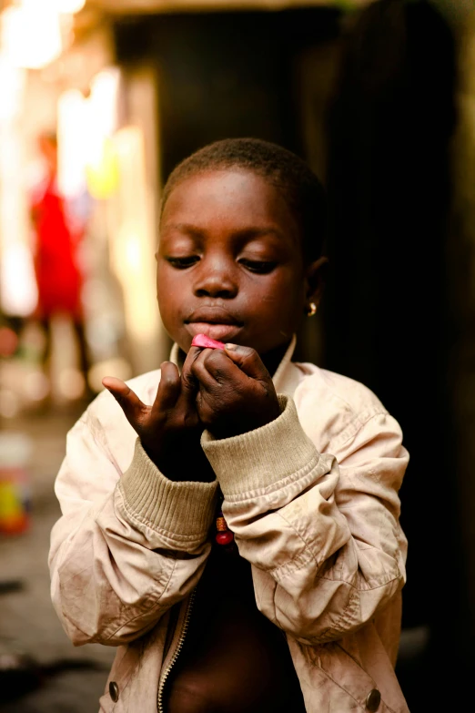 a young child is praying in an alley