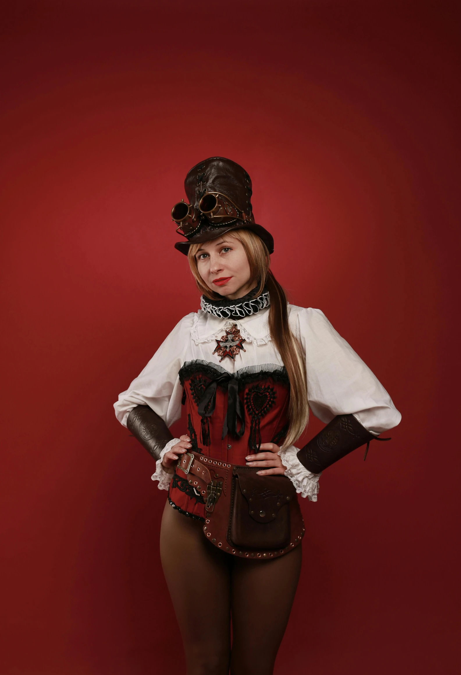 a woman dressed in costume poses with a red background