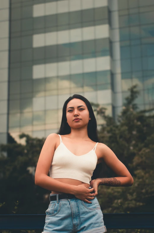 a girl poses with her arm resting on her hips