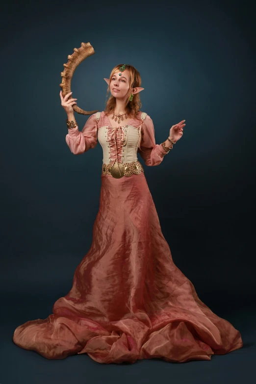 the woman in the costume is holding an instrument