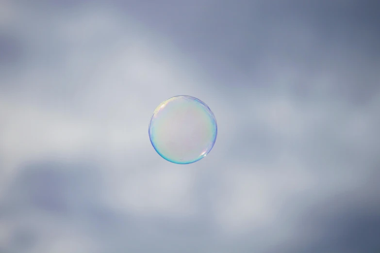 the sky has some clouds around it, and there is a soap bubble