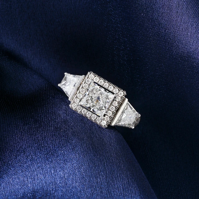 a ring sits on top of blue fabric