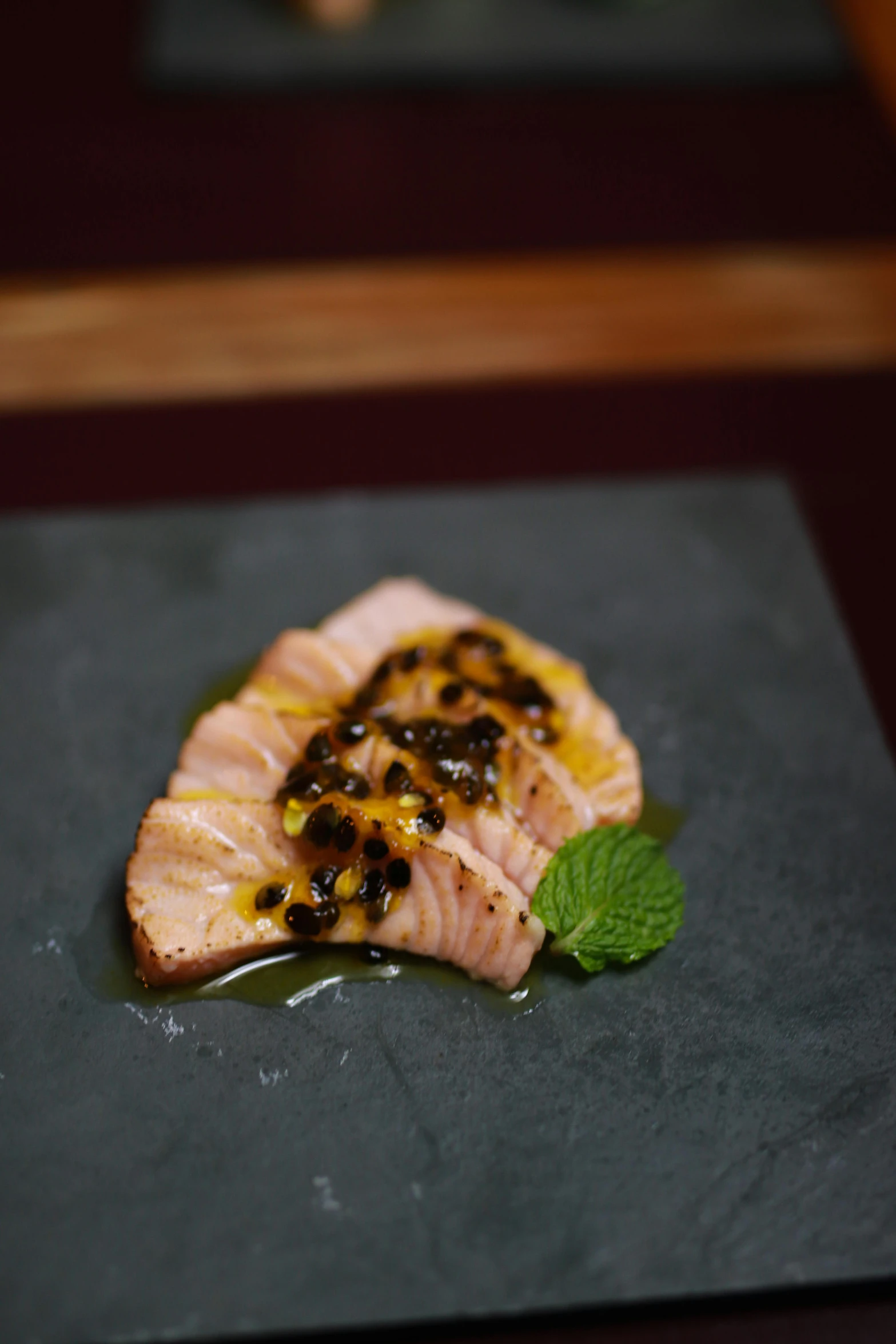 food is served on a slate plate with mint