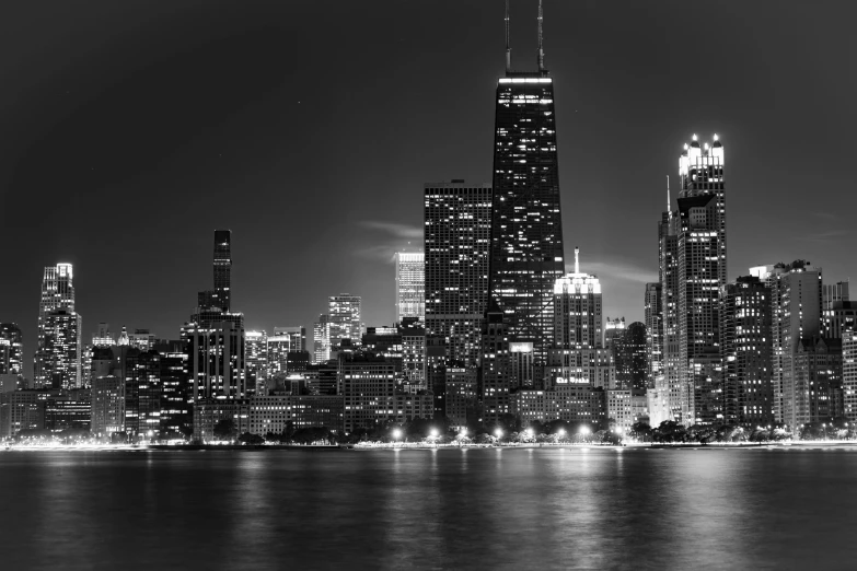 the view of a city skyline is lit up at night