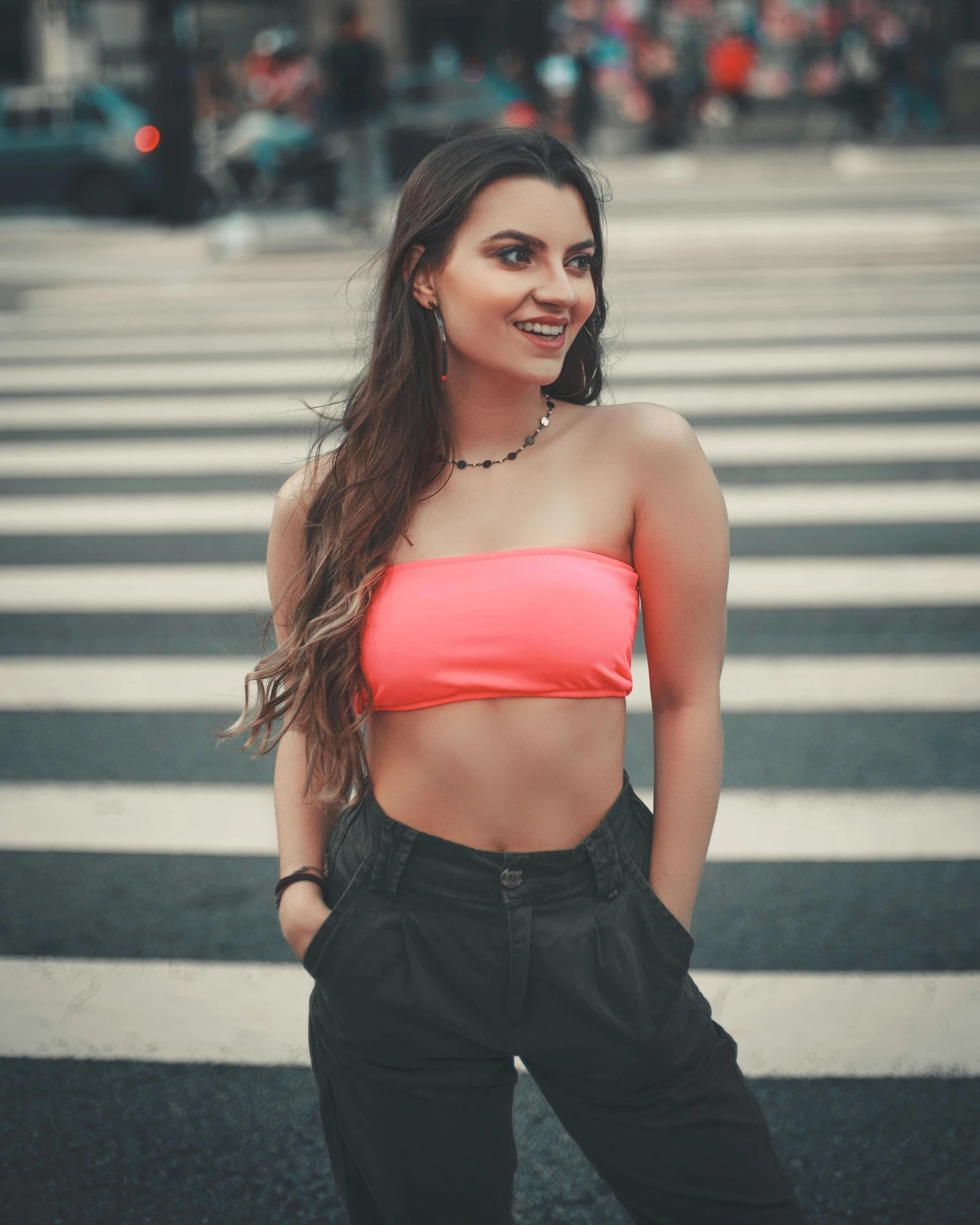 a young woman standing in the middle of a cross walk