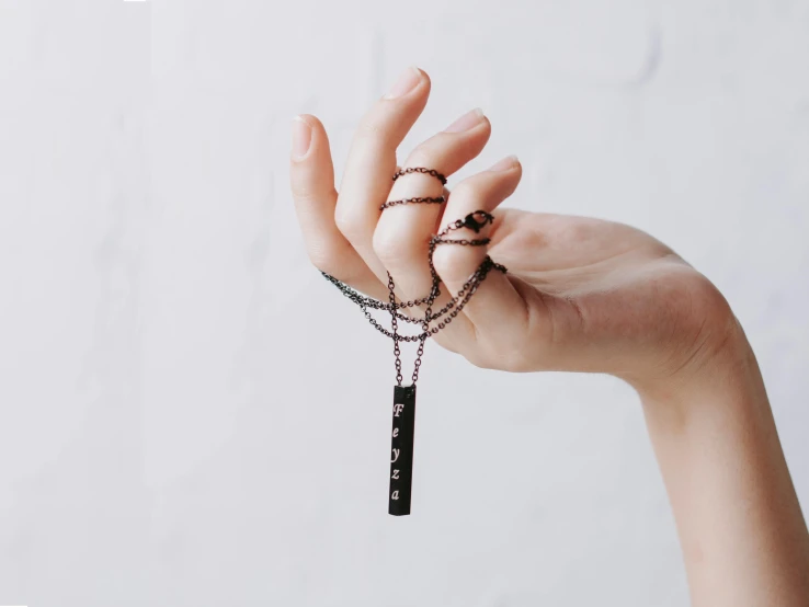 woman's hand with some beaded rings on it